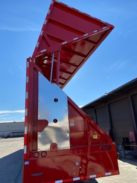 Crush car carrier trailer with deck tip-up door open, red gloss paint, reflective safety stripes, metal diamond plate panels.