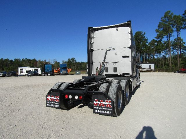Kenworth T680 rear view showing fifth wheel, dual rear axles, and mud flaps with J&R Truck Center branding.
