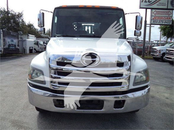Front view of a white 2017 Hino 258LP hooklift truck with chrome grille and large bumper.