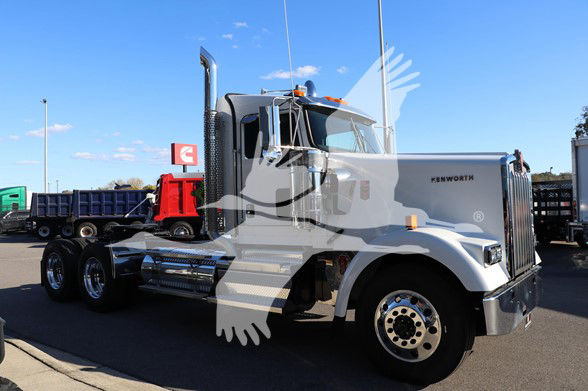 Kenworth W900L conventional daycab truck showing front and side with chrome exhaust stacks and dual rear axles.