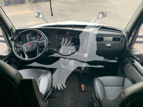 Kenworth T680 truck interior dashboard, steering wheel with Kenworth logo, instrument cluster, center console, and two front seats. Visible text on dashboard and controls.
