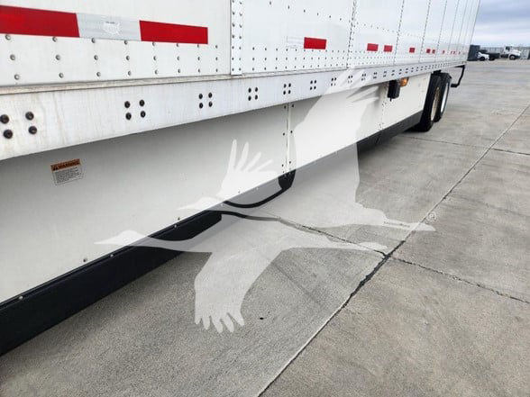 Trailer side view showing lower side skirt and wheel area of a 2021 Wabash trailer with stock number 2110-2116 and VIN 1JJV532D8ML246170.