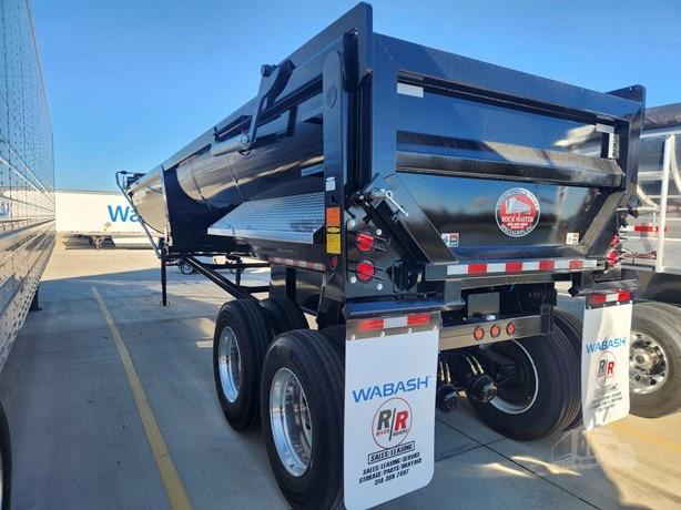Construction trailer with 34' steel end dump, dual rear axle with black dump bed, mirrors, taillights, and white Wabash mud flaps.