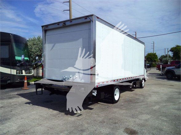 Isuzu NRR box truck with rear roll-up door and dual rear wheels, white cargo box, parked in lot.