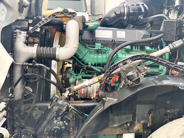 Volvo VNL 670 engine bay showing green engine block and various hoses and components.