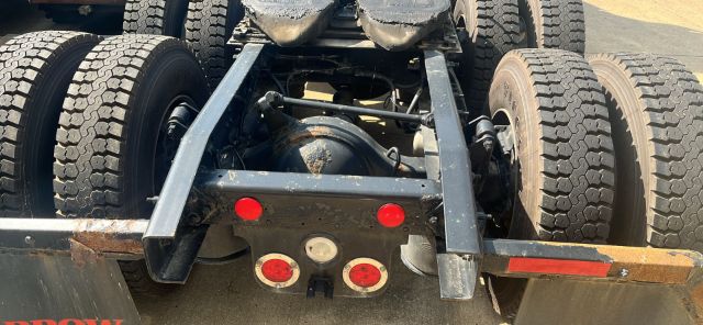 Freightliner Cascadia truck chassis rear view showing dual rear axles and fifth wheel mounting area with tires.