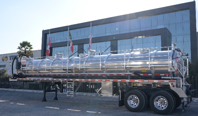 Voluminous aluminum vacuum trailer 150BBL with polished cylindrical tank, dual rear axles, support stairs, and safety railing; exterior shows reflective surface and mounted hose fittings.