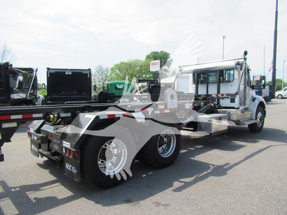 Kenworth T480 truck chassis with cab and wheelbase visible; rear view shows flatbed/tipper area and dual rear axles; no legible model badges visible from this angle.