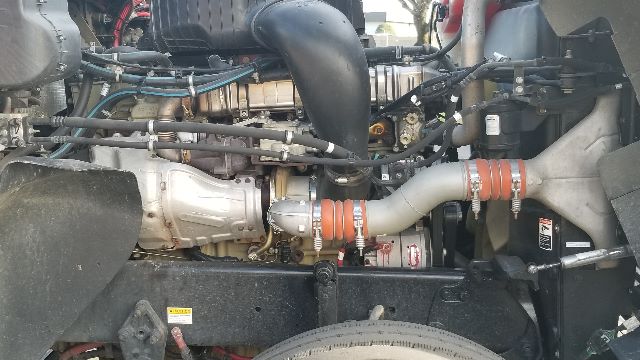 Coronado 132 engine bay showing large intake manifold, turbo piping, hoses, and surrounding components.