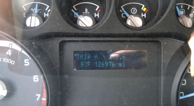 Dashboard display shows 'TRIP A  6.6' and '97F 126976 mi' with analog gauges around.
