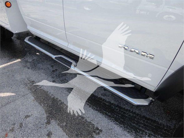 Ram 5500 SLT truck side view showing chrome running boards and RAM badge on the door.