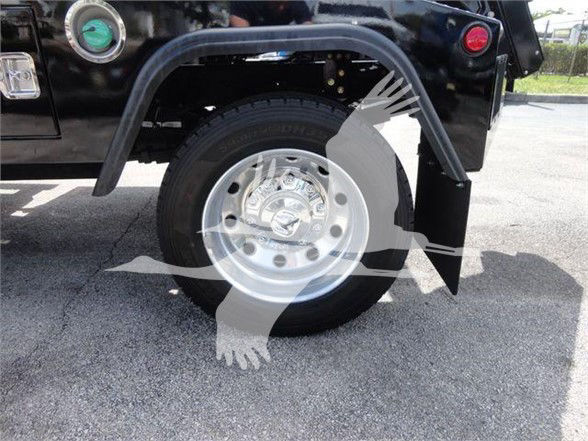 Ram 4500 fender and wheel assembly showing tire and chrome hubcap with mudguard.