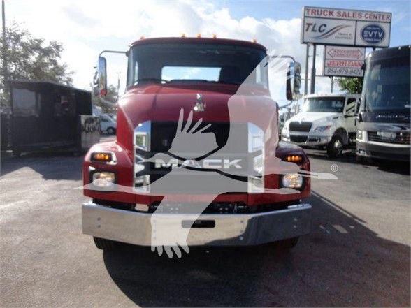 Front view of a red 2024 Mack MD6 tow truck showing Mack grille, headlights, and chrome bumper.