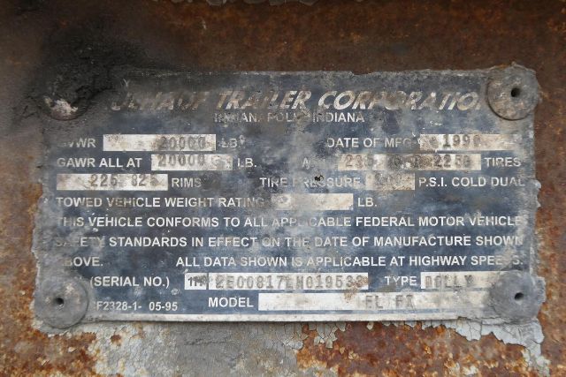 Identification plate on Fruehauf trailer showing VIN 1H2E00817LH019533, stock 0507245, model ELFI, date 1990, gross axle weight rating 2000 lb, tires 235/?, serial number 12300017 019533.