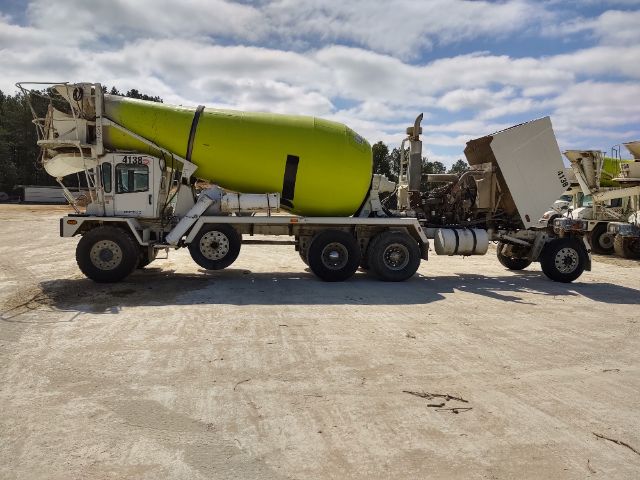 Terex FDB5000 concrete mixer truck with lime green drum on a multi-axle chassis, side view showing mixer and chute, used condition.