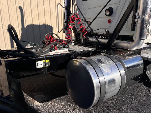Mack CHU613 Pinnacle truck chassis fuel tank and rear cab area showing air lines and wiring harnesses.