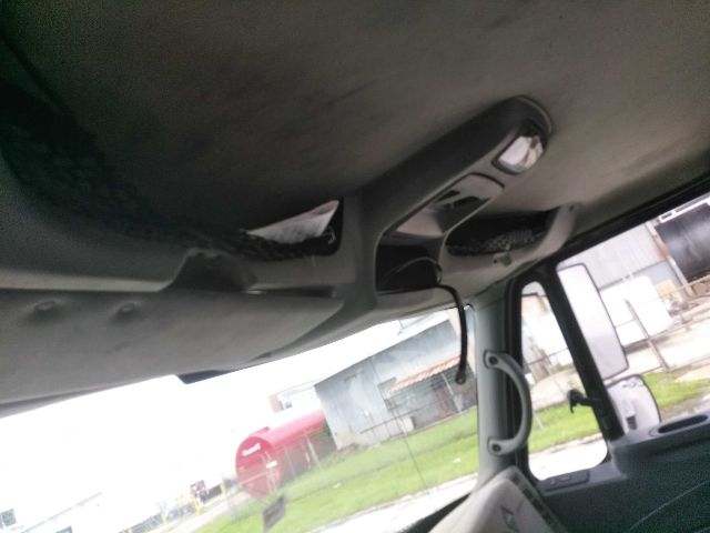 Interior view of a truck cab showing overhead console and sun visor area
