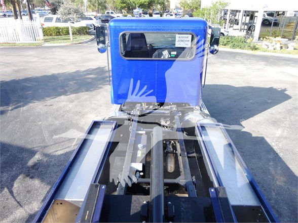 Blue Peterbilt truck cab back view with chassis and trailer hitch area visible.