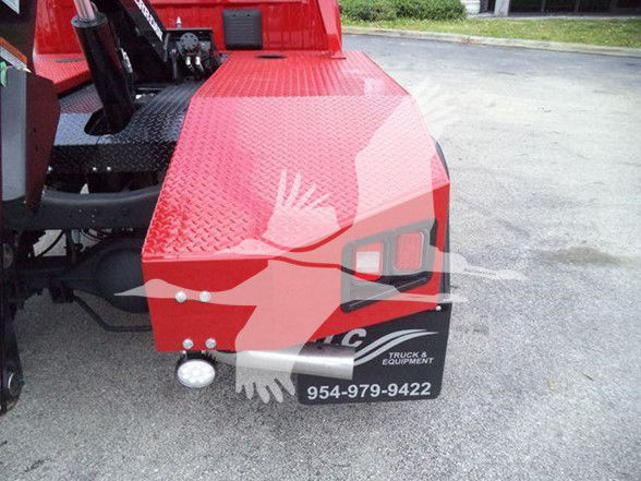 Ram 4500 tow truck rear with red diamond plate bed, license plate area shows 954-979-9422 and truck equipment logo.