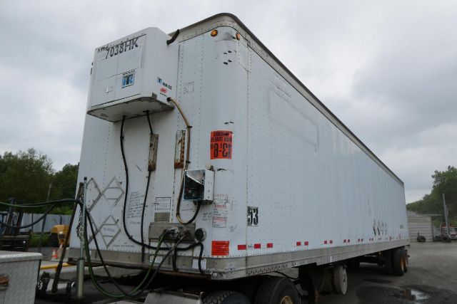 Great Dane trailer with reefer unit mounted at front, white exterior, rear view showing hydraulic lines and entry door.