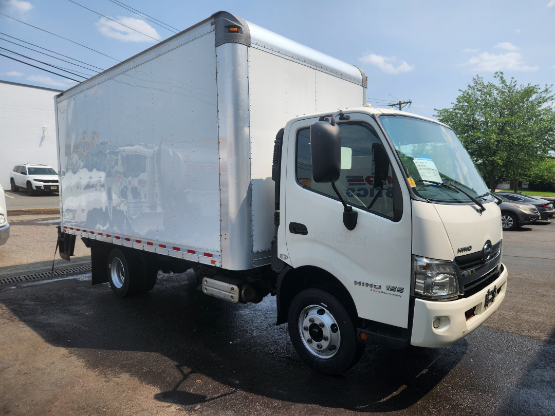 2017 Hino 155 box truck with white cab and large box cargo area, side view on wet pavement, stock number U483, VIN JHHYDM1H7HK003848.
