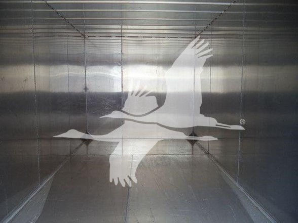 Trailer interior with a large white seagull logo and reflections visible along the metal walls.
