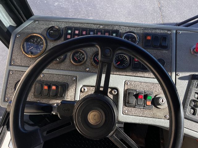 Vehicle cockpit view of a 2013 Tico Prospotter DOT showing steering wheel, gauges, and control switches.