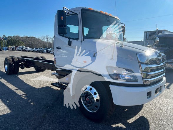White 2025 Hino L6 cab chassis truck showing front and side view with no bed attached. Visible text: none on image; stock listing context nearby.