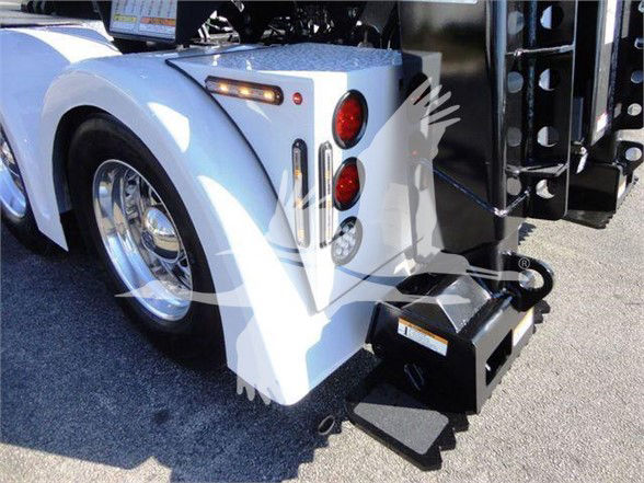 Freightliner Business Class M2 106 rear fender and tail light area with hitch and mounting equipment visible.