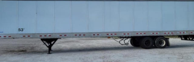 Trailer side with landing gear, wheel group and 53" marking on frame; blue-gray trailer body.