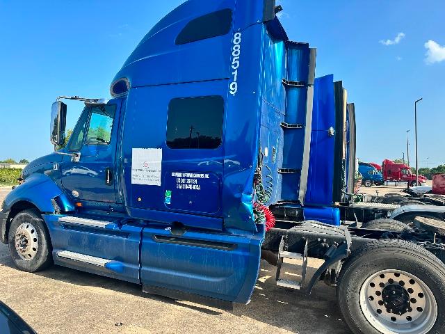 Blue 2017 International Prostar sleeper cab truck side with rear fender, exhaust stacks, and wheels visible.