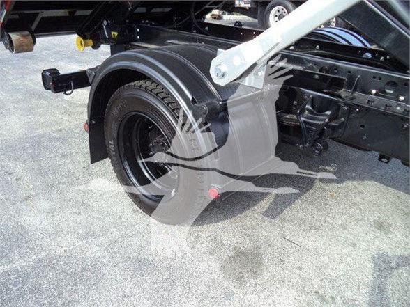 Chevrolet Silverado 6500HD truck rear wheel well and chassis visible with spare wheel housing and mudflap. Partial view of suspension and frame.