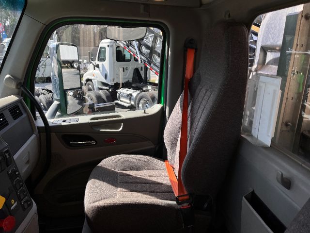 Peterbilt 579 truck cab interior with gray fabric seat and orange seat belt.