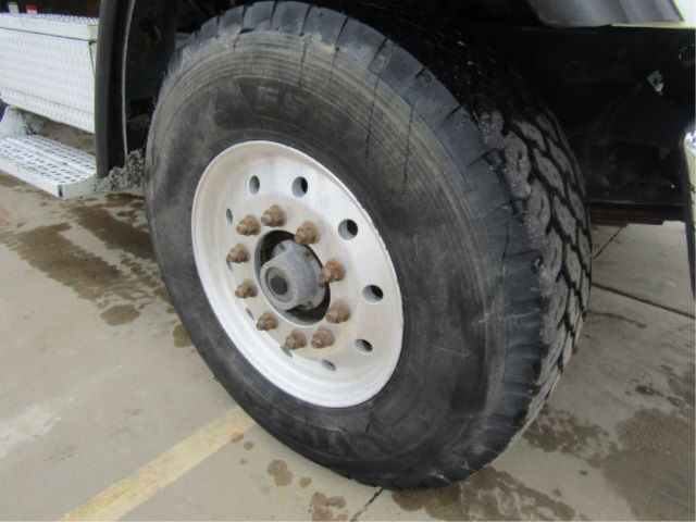 Wheel close-up on a heavy-duty truck with large tire and hub studs.
