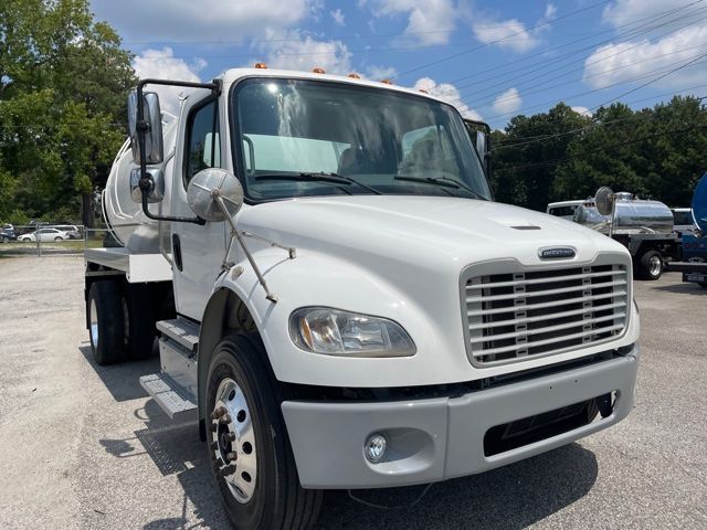 Freightliner M2 sewer service truck in white, front three-quarter view showing grille, cab, and side mirrors.