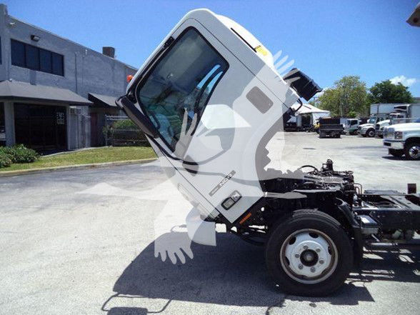 Isuzu NQR cab tilted forward showing front wheel and chassis, 2022 model, used dump truck.