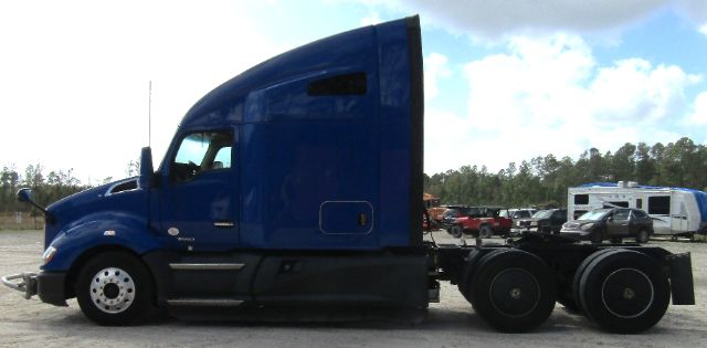 Kenworth T680 cab and chassis side view with blue cab and black chassis tires.