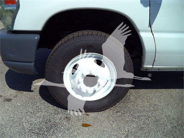 Ford E-450 wheel well and front fender visible; no legible labels on the tire, wheel, or surrounding area.