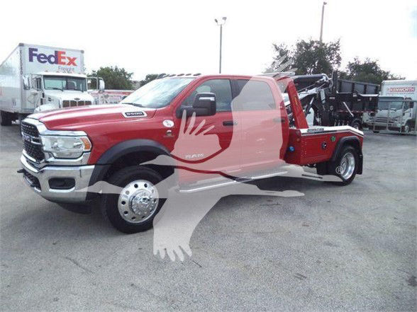 Ram 5500 tow truck with red body and crane equipment in lot; visible text includes Dex shown on front badge and RAM 5500 emblem on door.