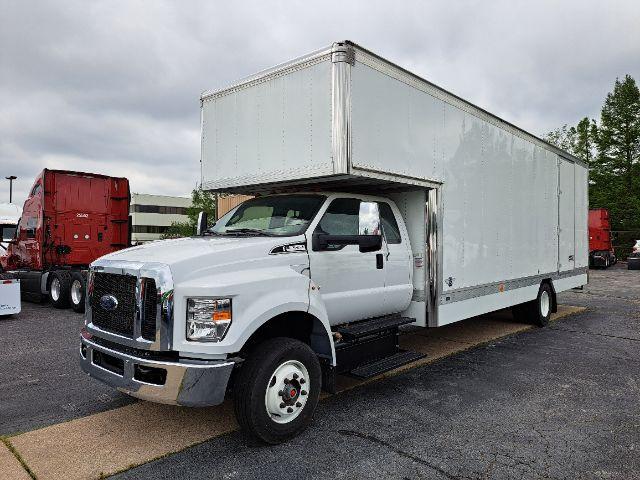 Ford F-650 box truck, white, front-left angle, cargo box attached, in dealership lot.