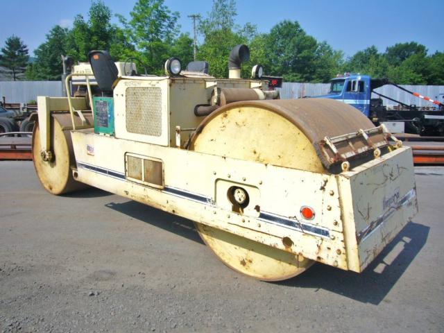 Ferguson 10-14B road roller with large front drum and rear drum, cream color with blue stripe, operator seats and controls visible.