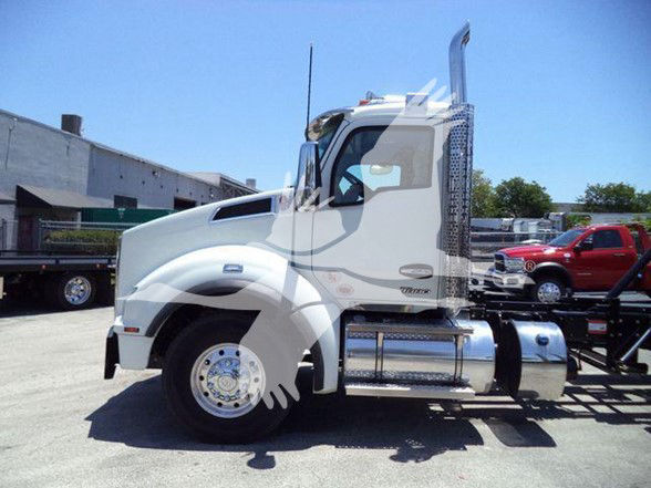 Kenworth T880 truck side view with long hood, white cab, chrome fuel tanks, and exhaust stacks. No visible text legible on labels from distance.