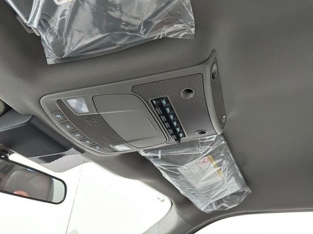 Ford F-550 interior overhead console with control panel and sun visor bag visible.