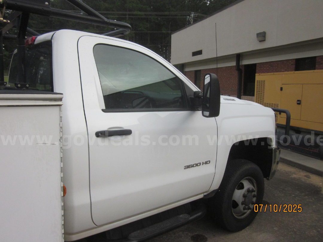 Vehicle side view of a white 2017 Chevrolet Silverado 3500HD with cab door, side mirror, and 3500 HD badge visible.