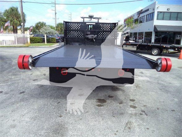 Hino 258LP hooklift truck bed rear view with red cones on ends and black Diamond plate deck.