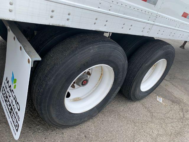 Manac dry van trailer wheels and lower side with dual rear axles.