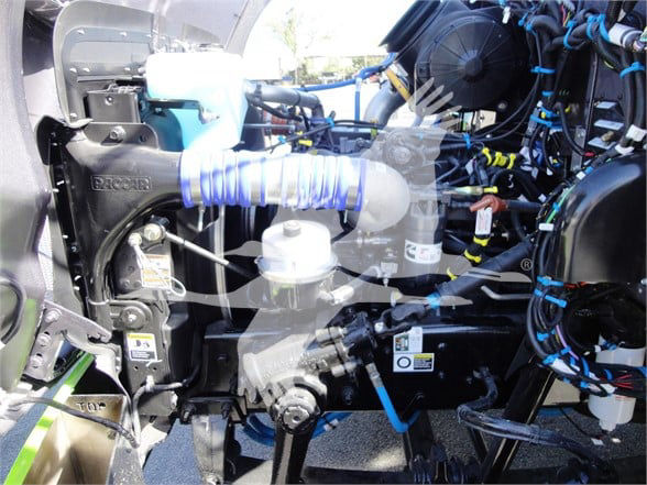 Peterbilt 337 engine bay showing turbo hose, hoses, wiring, and components in blue and black; visible labels and fittings.