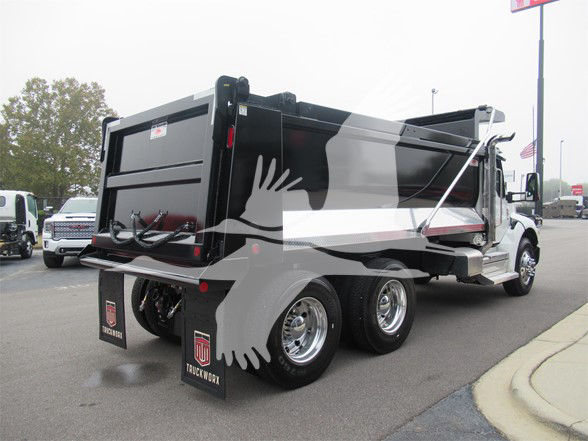 Kenworth T480 dump truck in showroom lot showing rear and side profile with dump bed and dual rear axles.