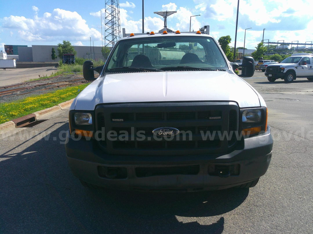 Front view of a white 2006 Ford F-350 service/utility truck with black grille, headlights, and bumper; stock number 8283-654 visible in listing.
