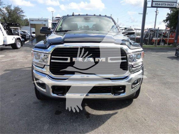 Front view of a 2023 Ram 5500 SLT truck with RAM grille and large black grille, chrome bumper, and 'RAM' emblem visible on the grille.